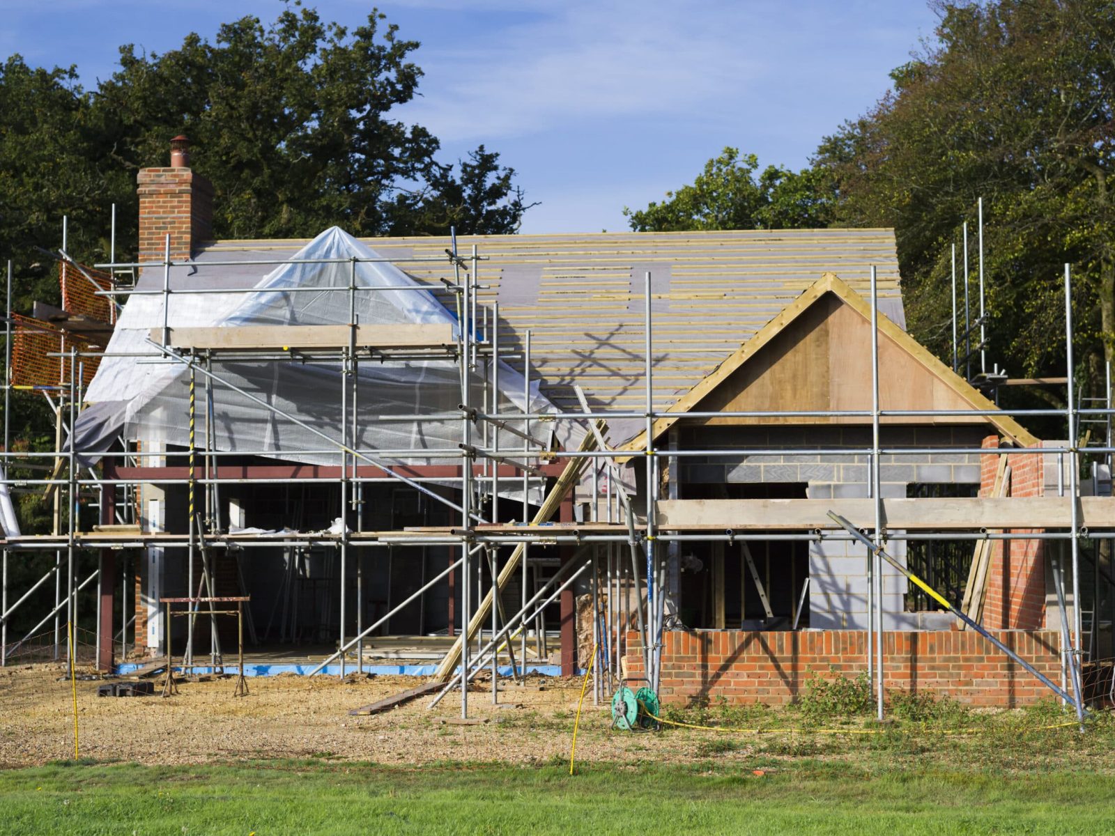 A family home under construction. A building site with scaffolding.
